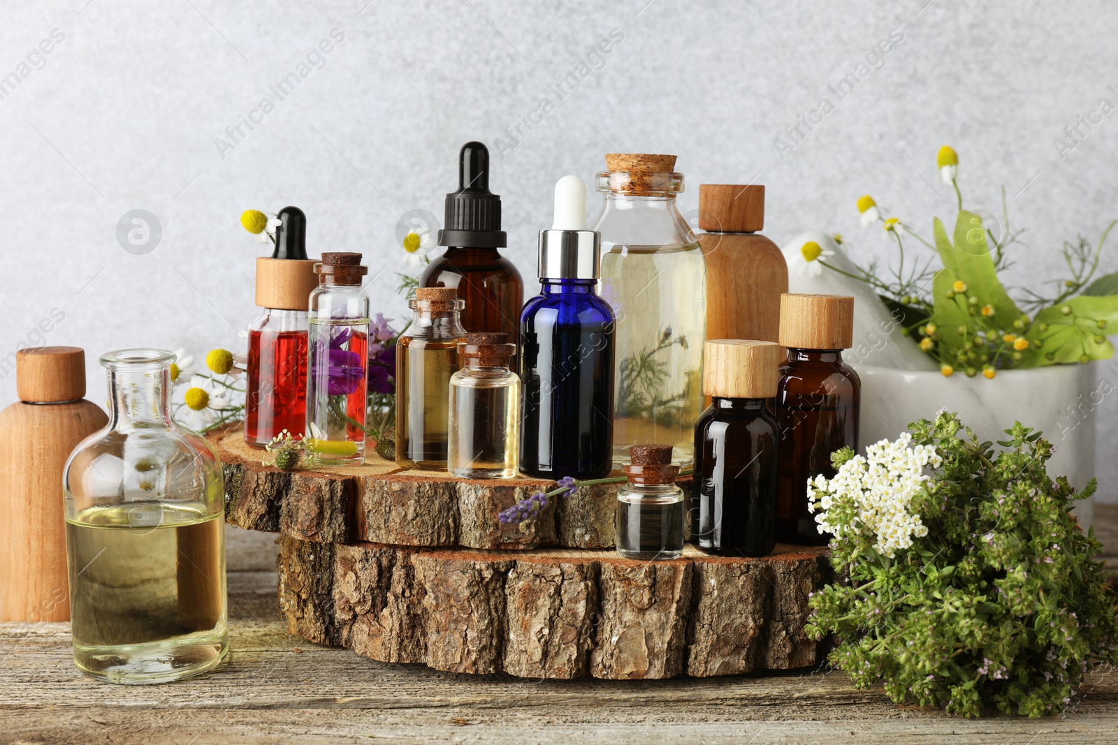 Photo of Aromatherapy. Different essential oils and flowers on wooden table