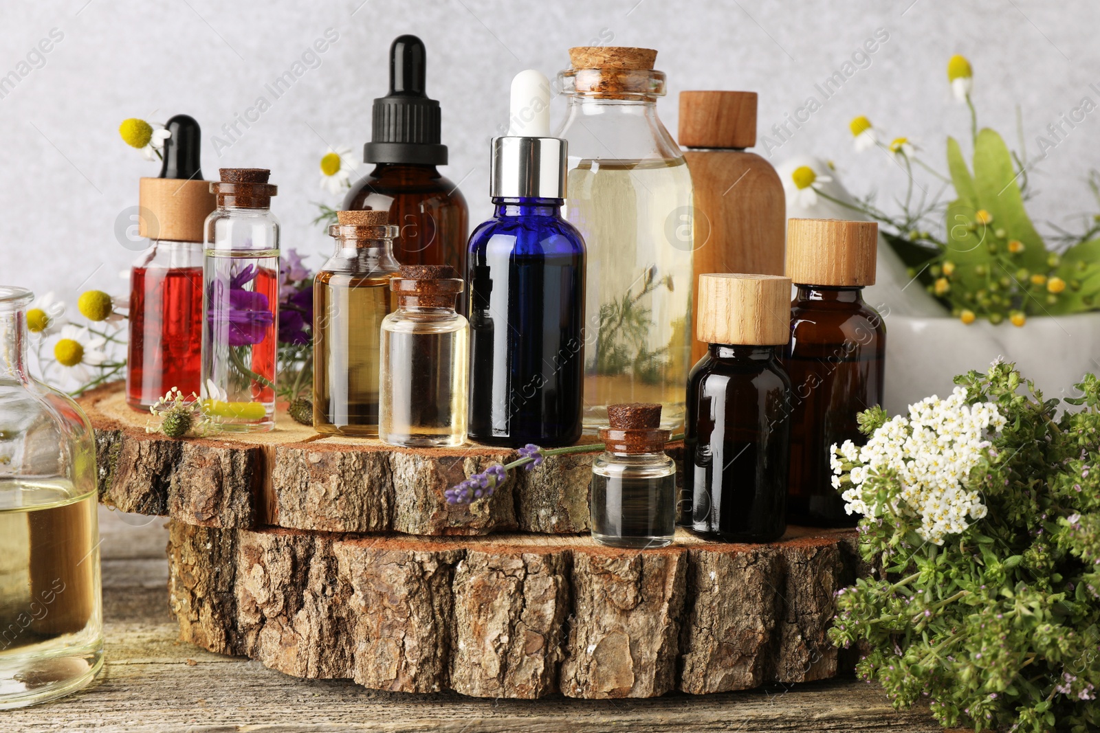 Photo of Aromatherapy. Different essential oils and flowers on wooden table