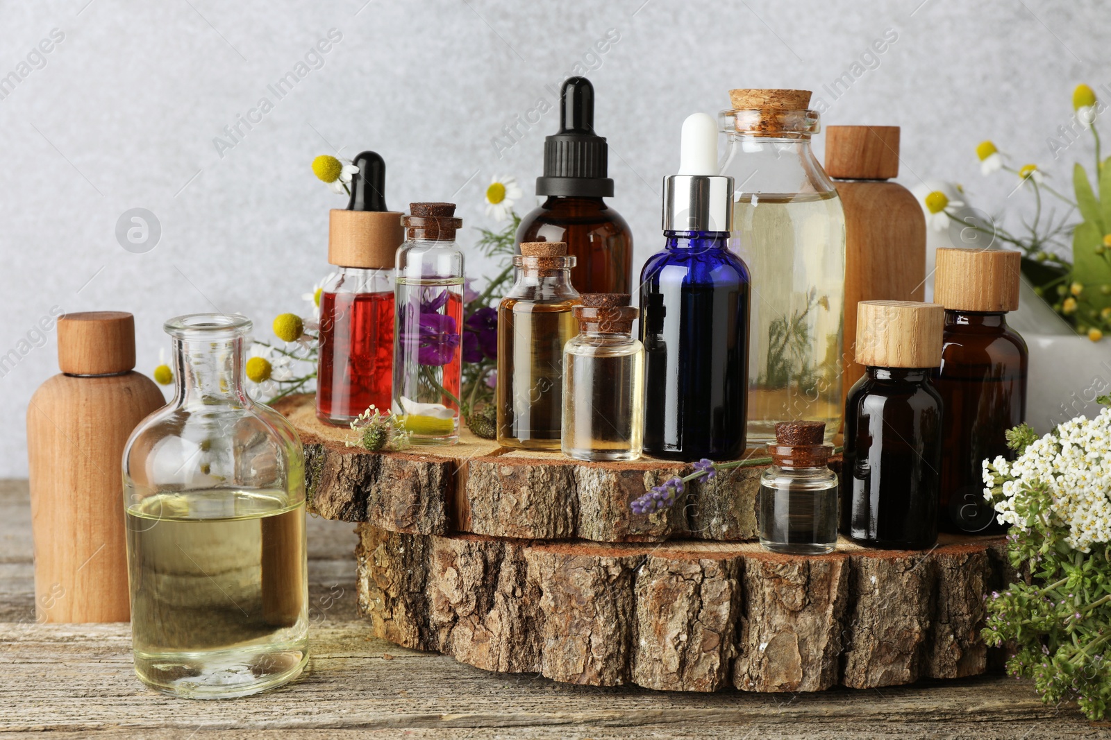 Photo of Aromatherapy. Different essential oils and flowers on wooden table