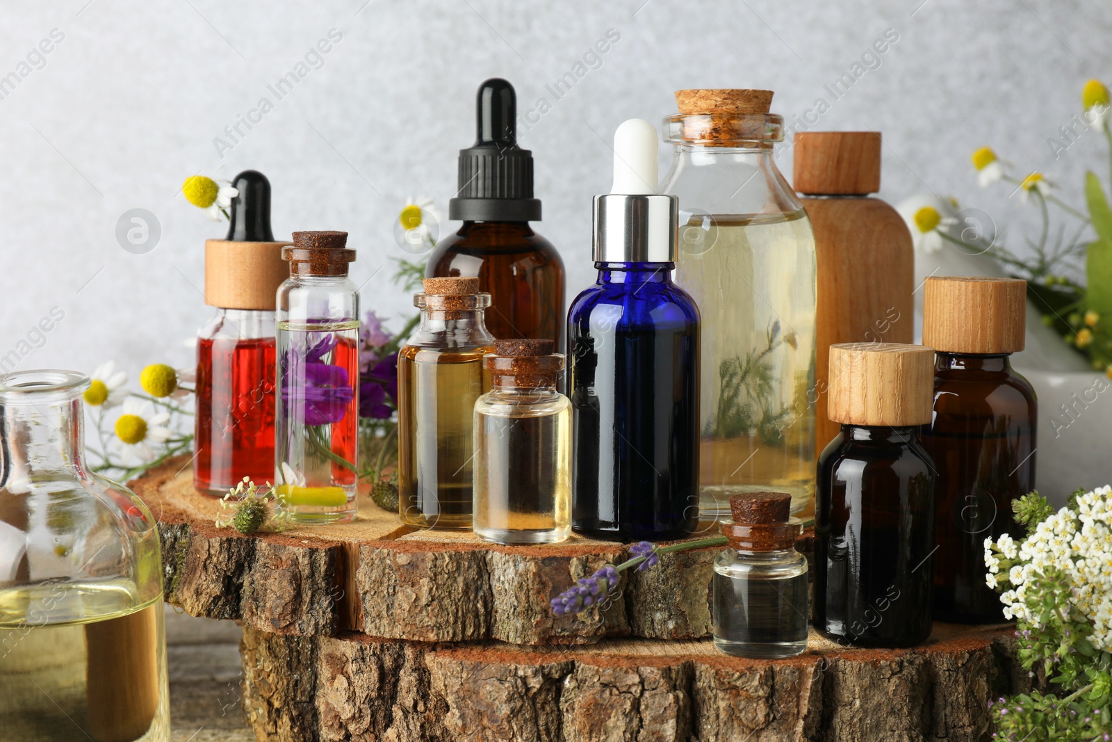 Photo of Aromatherapy. Different essential oils and flowers on wooden table