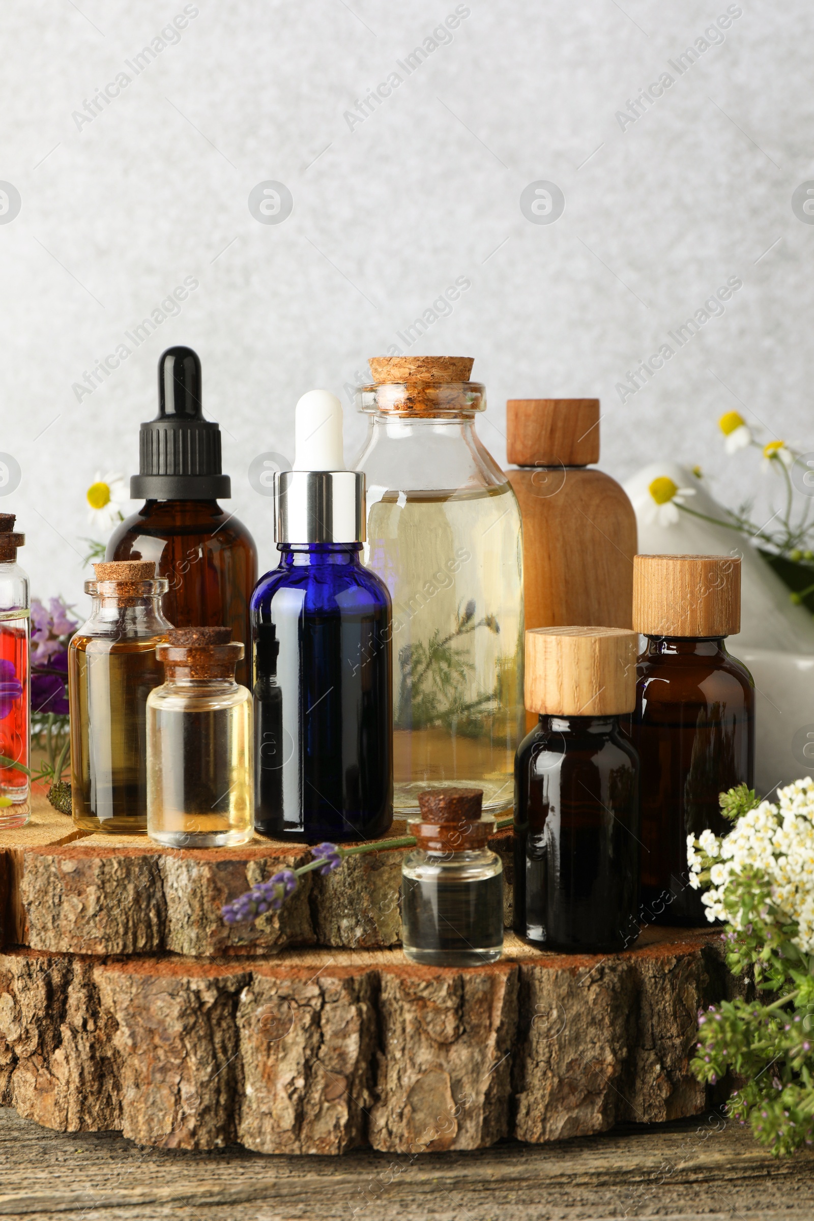 Photo of Aromatherapy. Different essential oils and flowers on wooden table