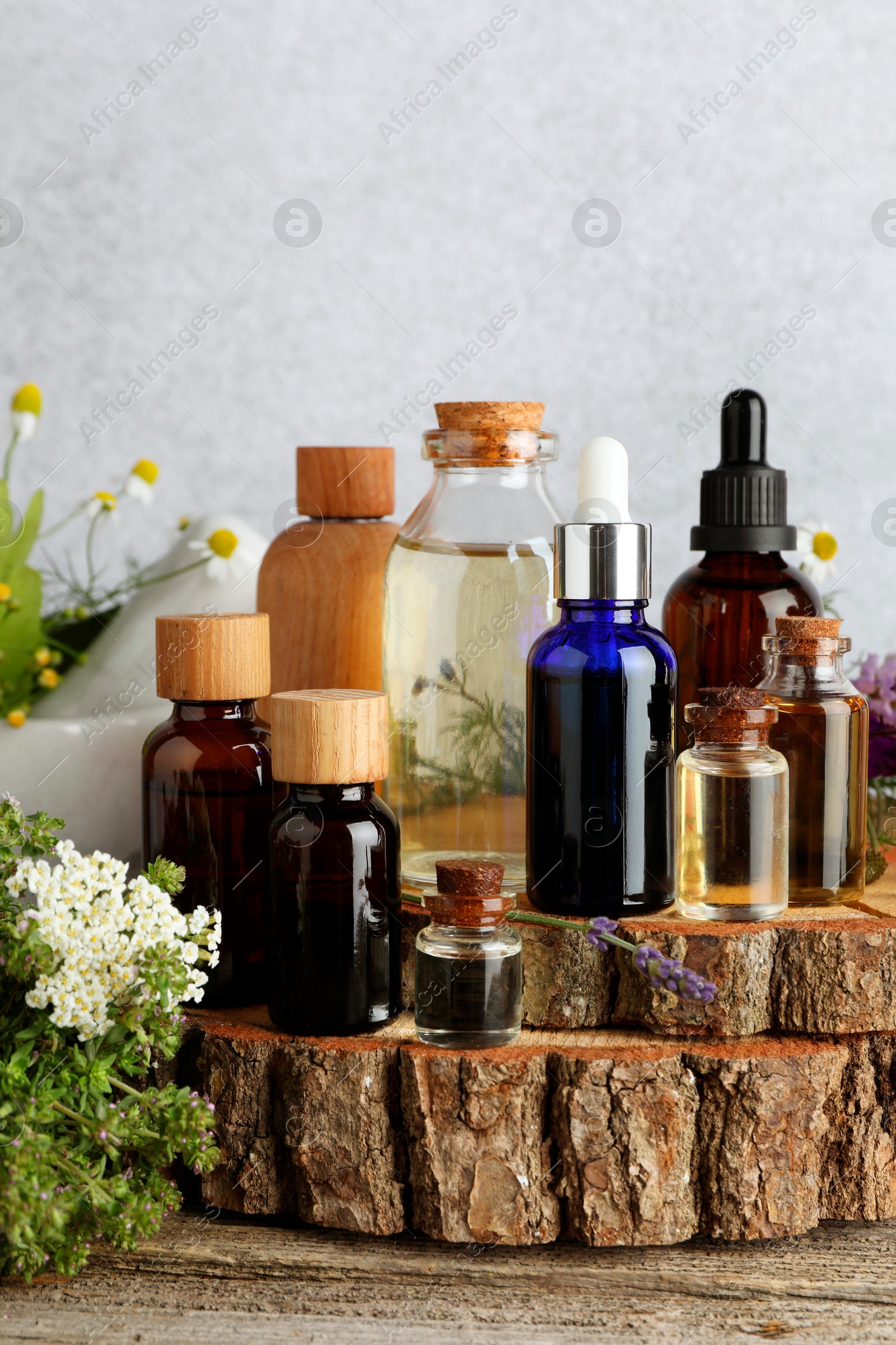 Photo of Aromatherapy. Different essential oils and flowers on wooden table