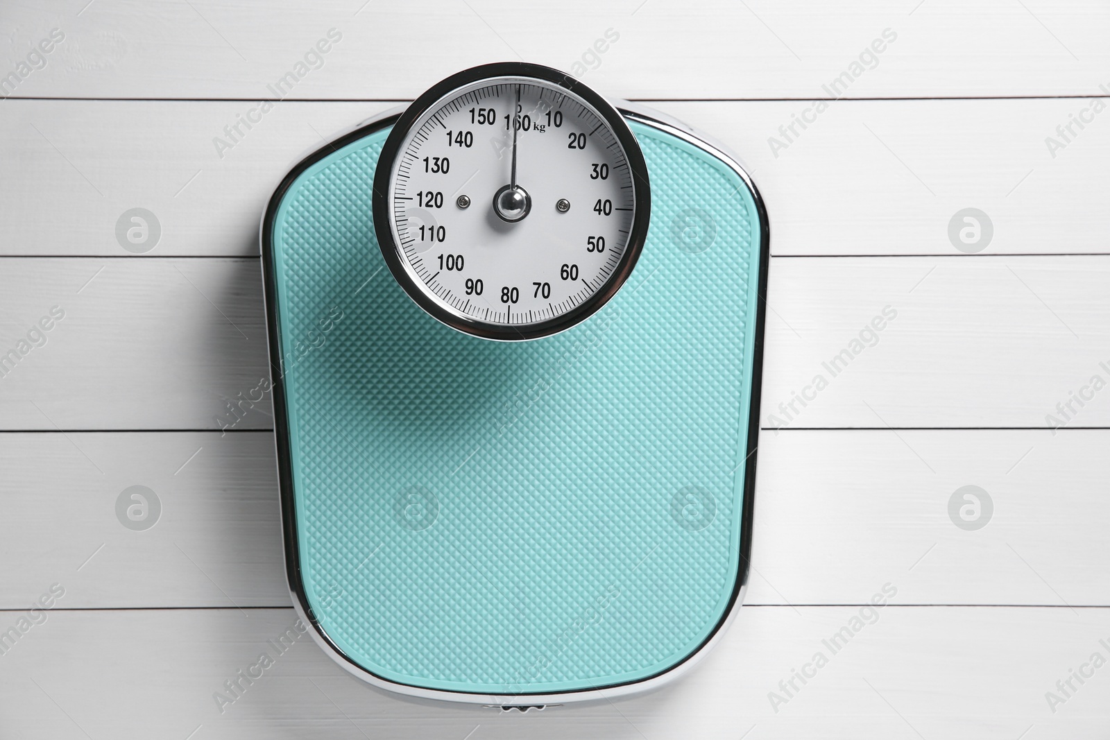 Photo of One bathroom scale on white wooden background, top view