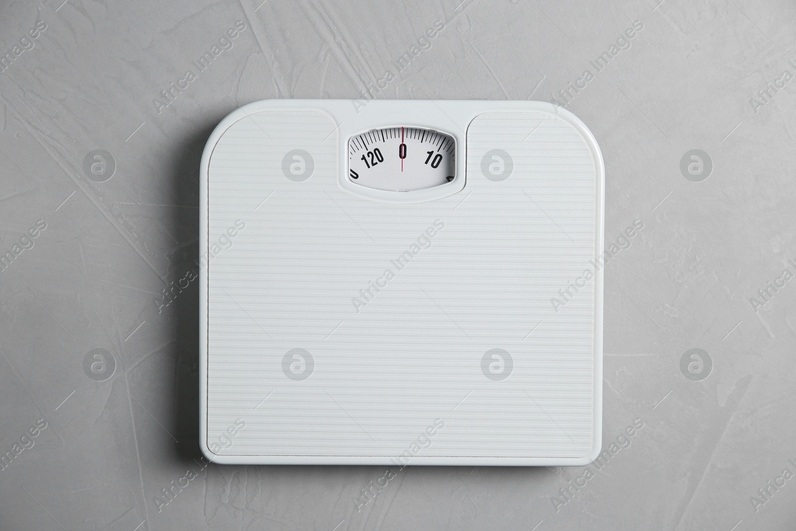 Photo of One bathroom scale on grey textured background, top view