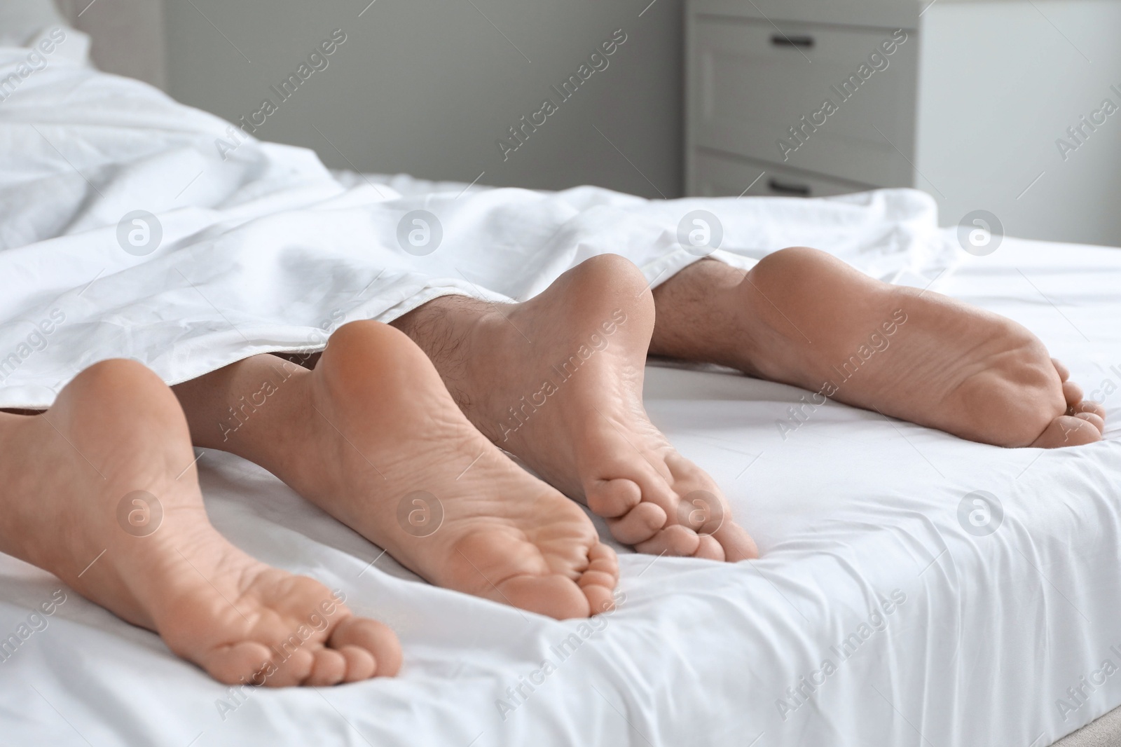 Photo of Lovely couple lying in bed at home, closeup view