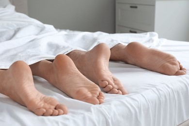 Photo of Lovely couple lying in bed at home, closeup view