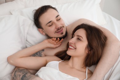 Lovely couple enjoying time together in bed at morning