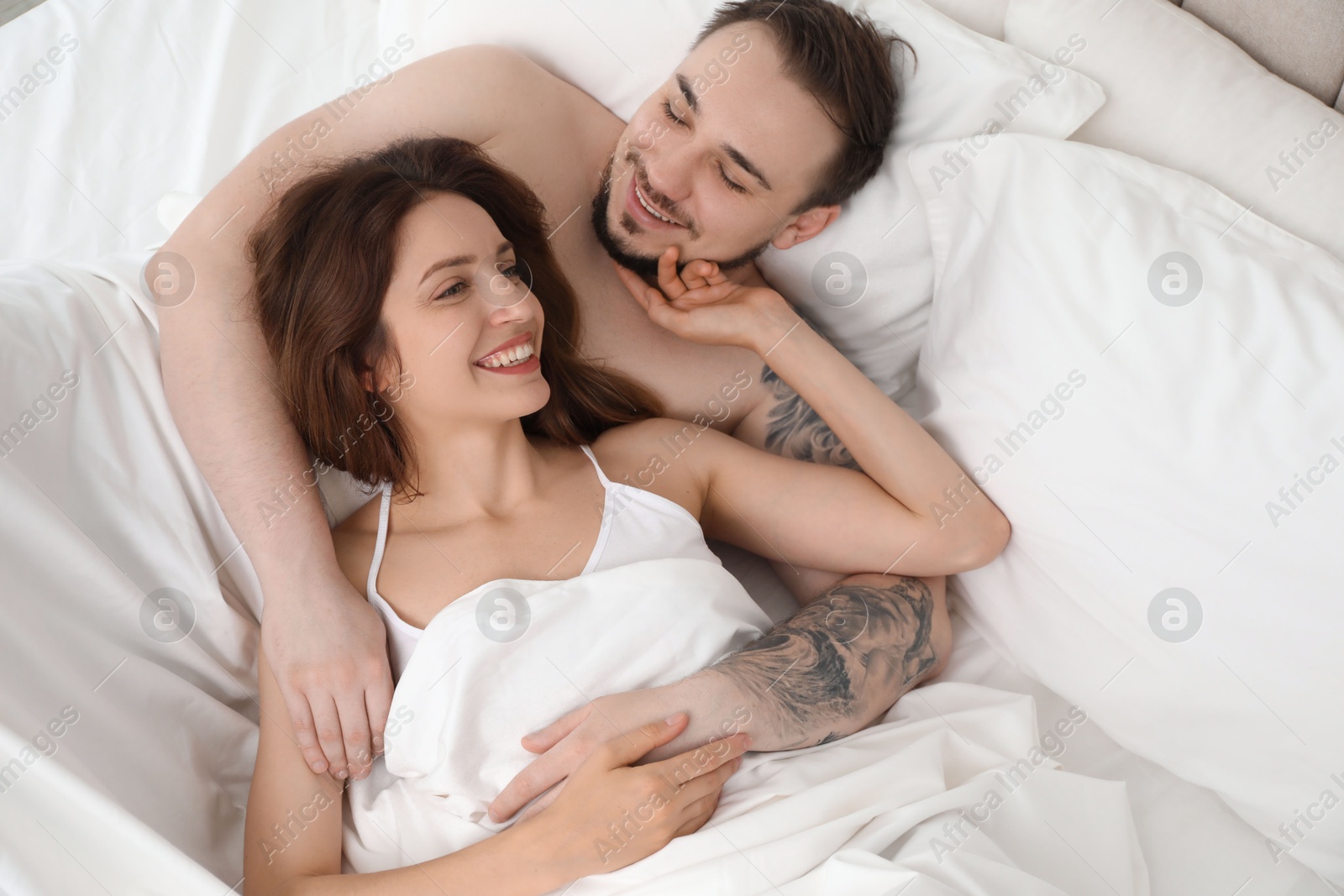 Photo of Lovely couple enjoying time together in bed at morning