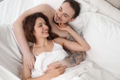 Lovely couple enjoying time together in bed at morning