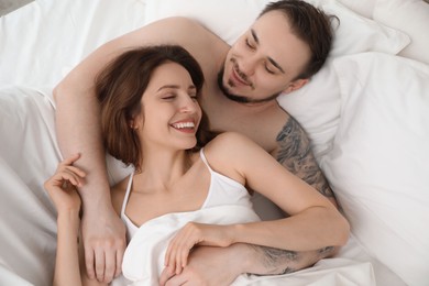 Lovely couple enjoying time together in bed at morning