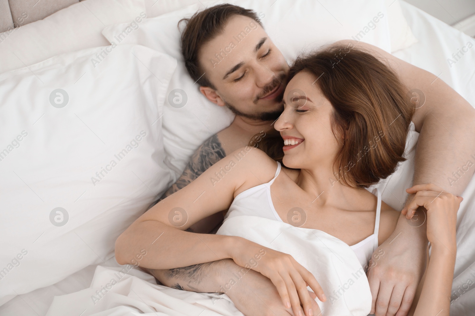 Photo of Lovely couple enjoying time together in bed at morning