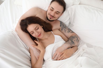 Lovely couple enjoying time together in bed at morning