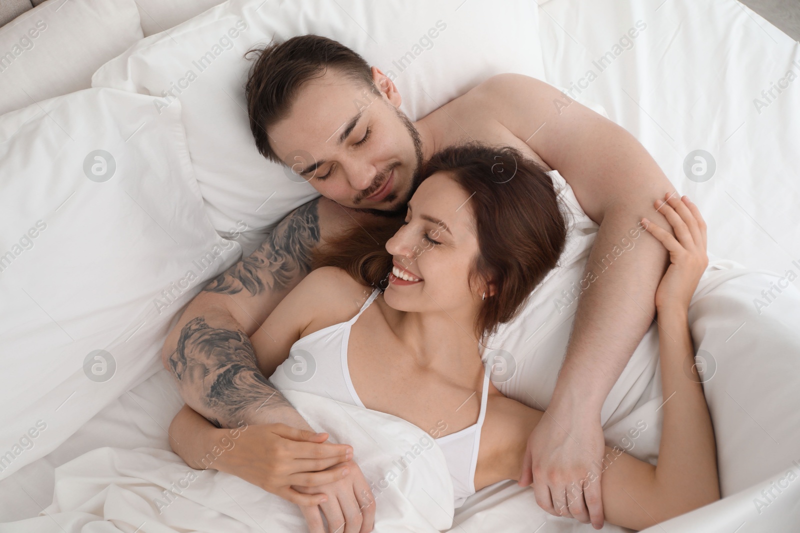 Photo of Lovely couple enjoying time together in bed at morning