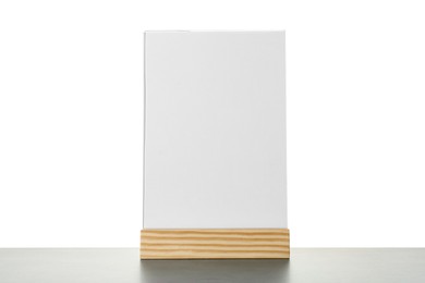 Photo of Menu holder on grey table against white background. Mockup for design