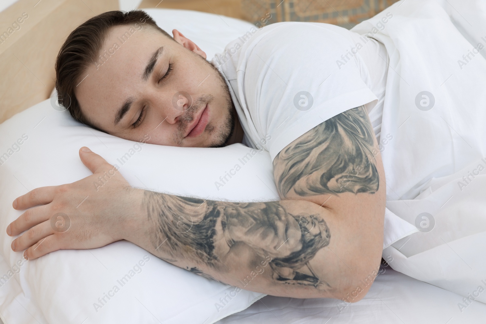 Photo of Bedtime. Handsome man sleeping in bed indoors