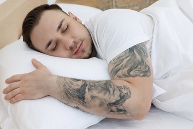 Bedtime. Handsome man sleeping in bed indoors