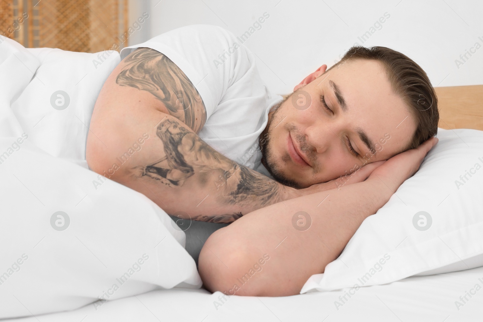 Photo of Bedtime. Handsome man sleeping in bed indoors