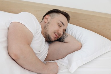 Bedtime. Handsome man sleeping in bed indoors