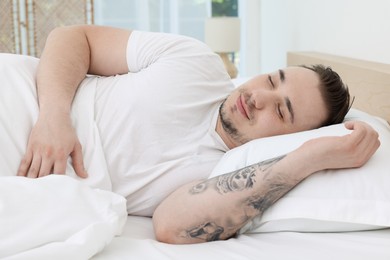 Bedtime. Handsome man sleeping in bed indoors