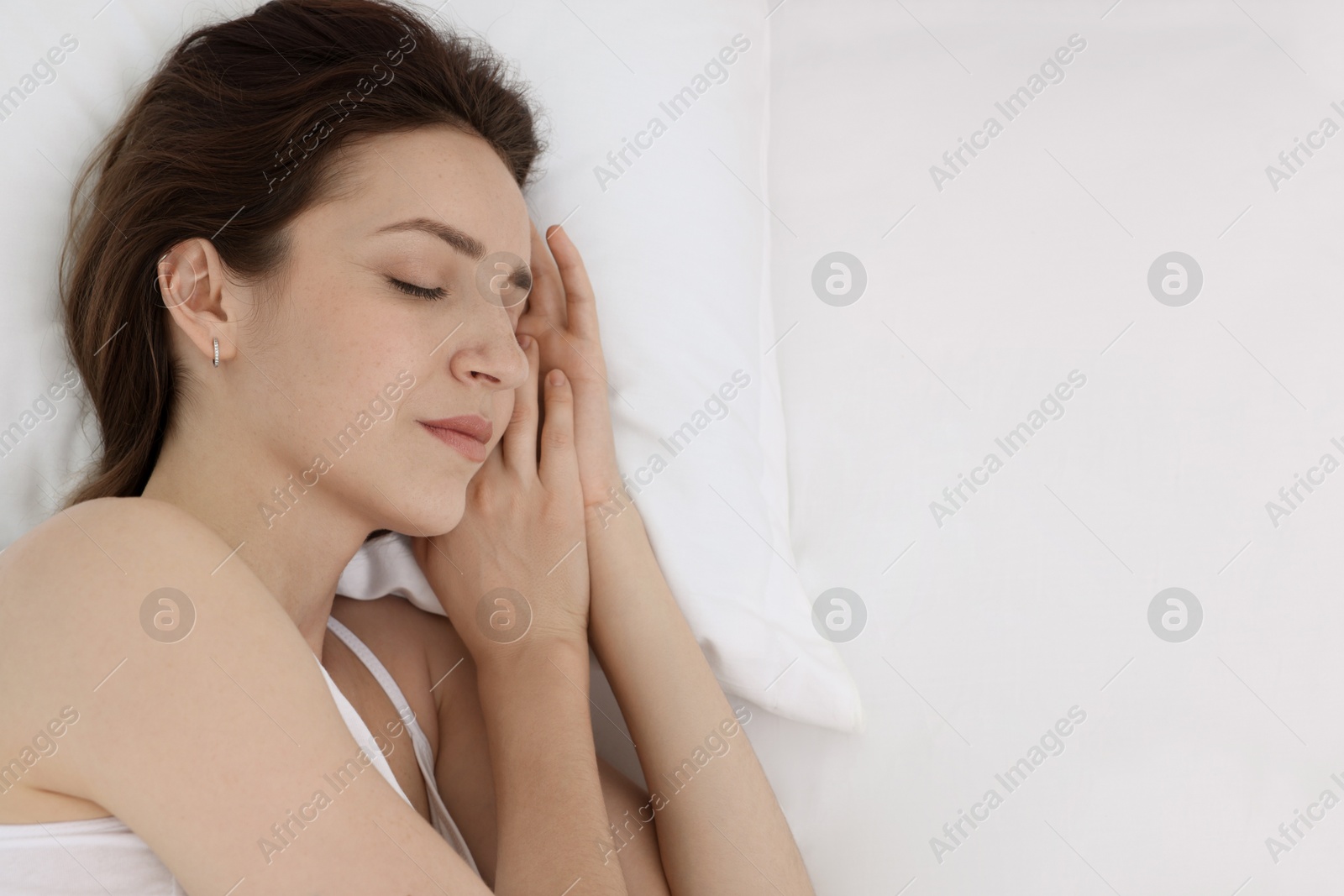 Photo of Bedtime. Woman sleeping in bed at home, above view. Space for text