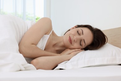 Photo of Bedtime. Woman sleeping in bed at home