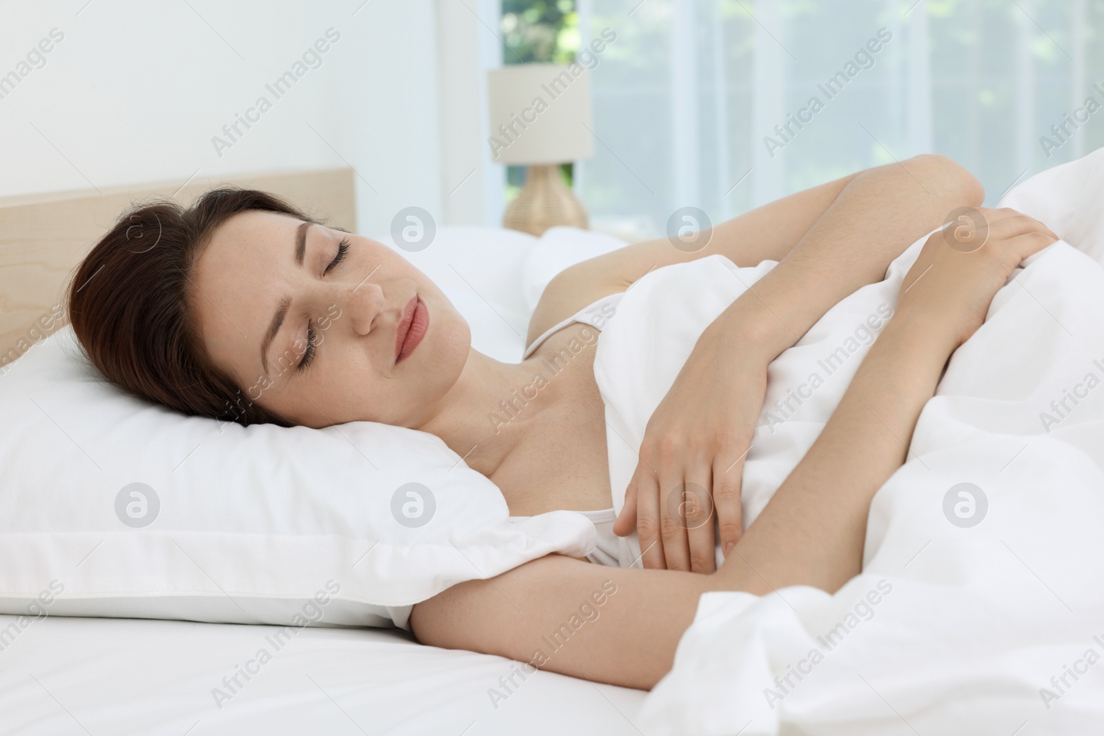 Photo of Bedtime. Woman sleeping in bed at home