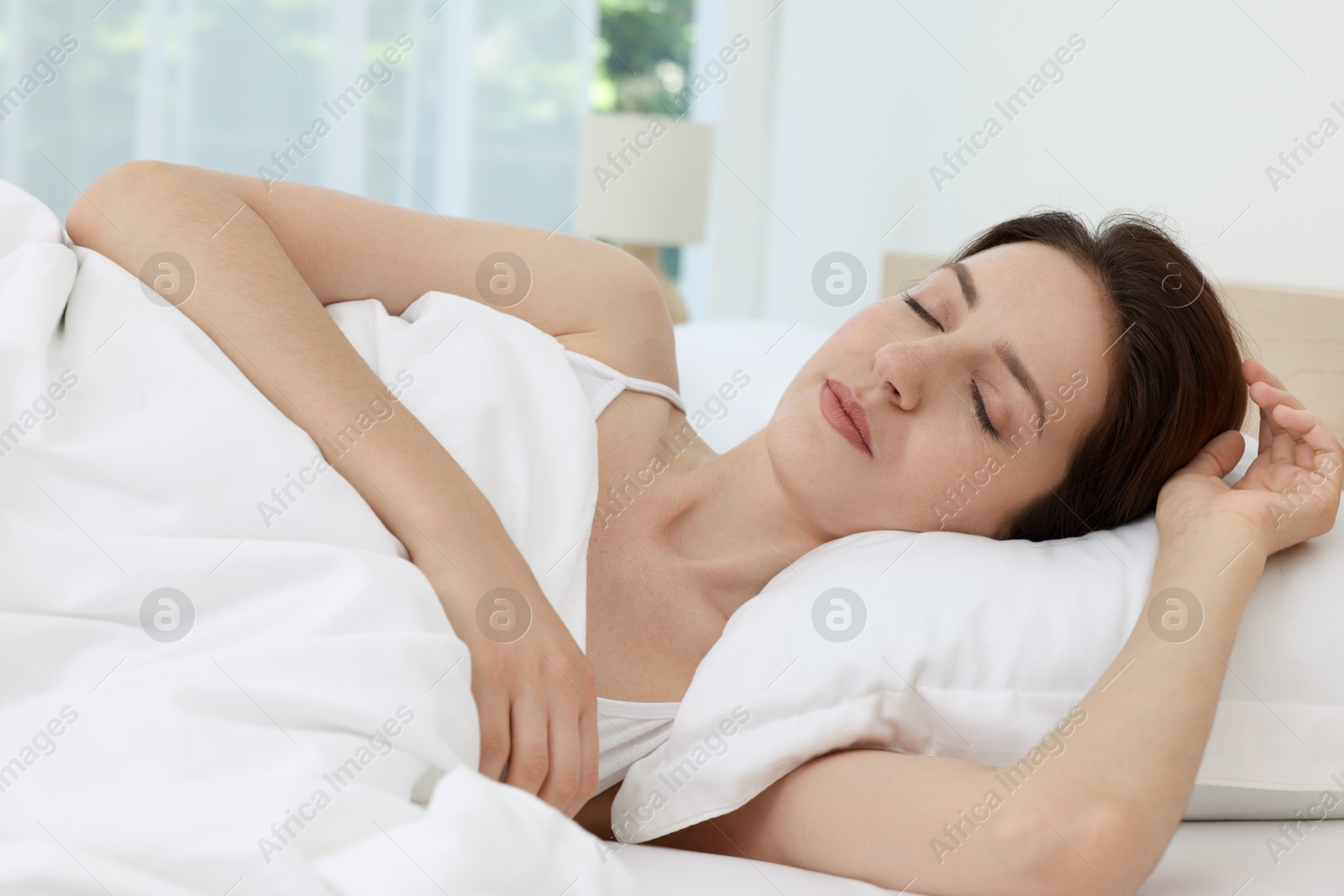 Photo of Bedtime. Woman sleeping in bed at home