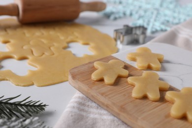 Making cookies. Board with raw dough on white table