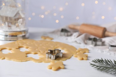 Making cookies. Raw dough and cutter on white table