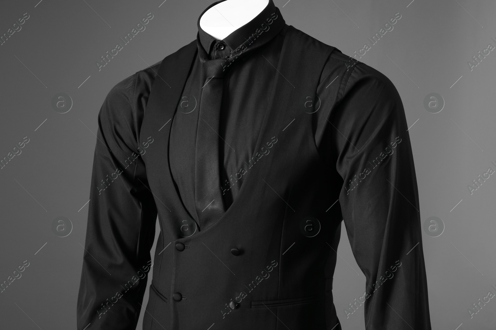 Photo of Male mannequin dressed in stylish black suit on grey background