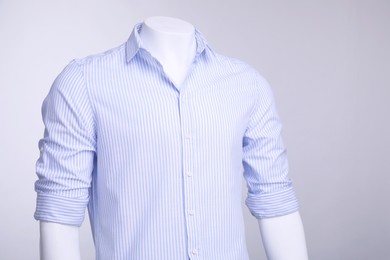 Photo of Male mannequin dressed in stylish shirt on grey background