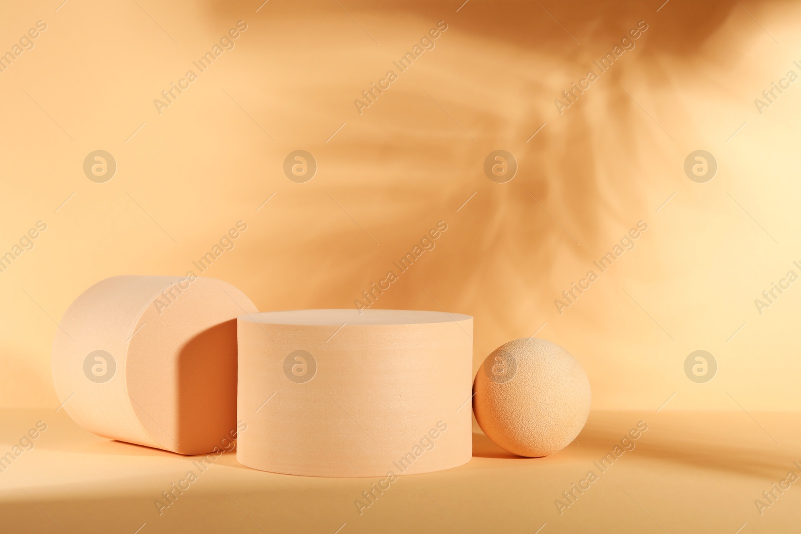 Photo of Presentation of product. Podiums and shadows on orange background. Space for text