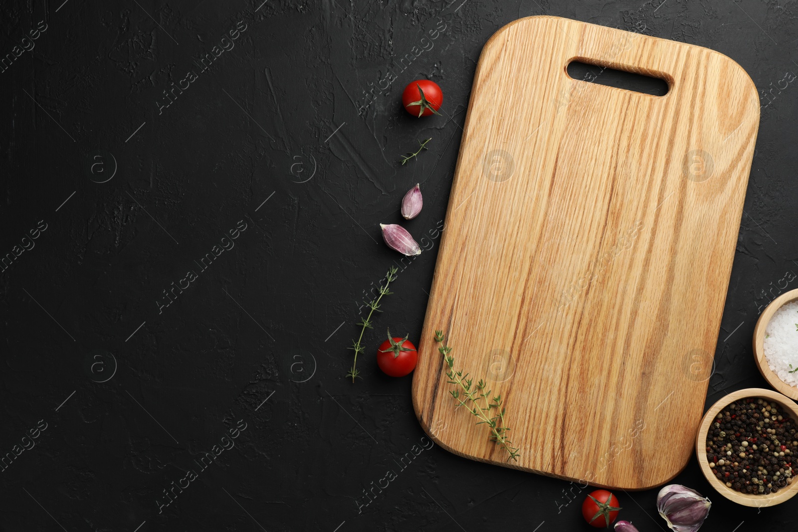 Photo of Cutting board, fresh tomatoes and different spices on grey textured table, flat lay. Space for text