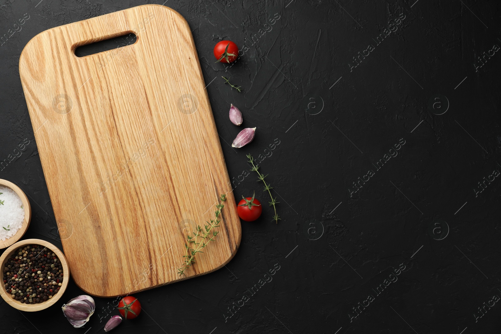 Photo of Cutting board, fresh tomatoes and different spices on grey textured table, flat lay. Space for text