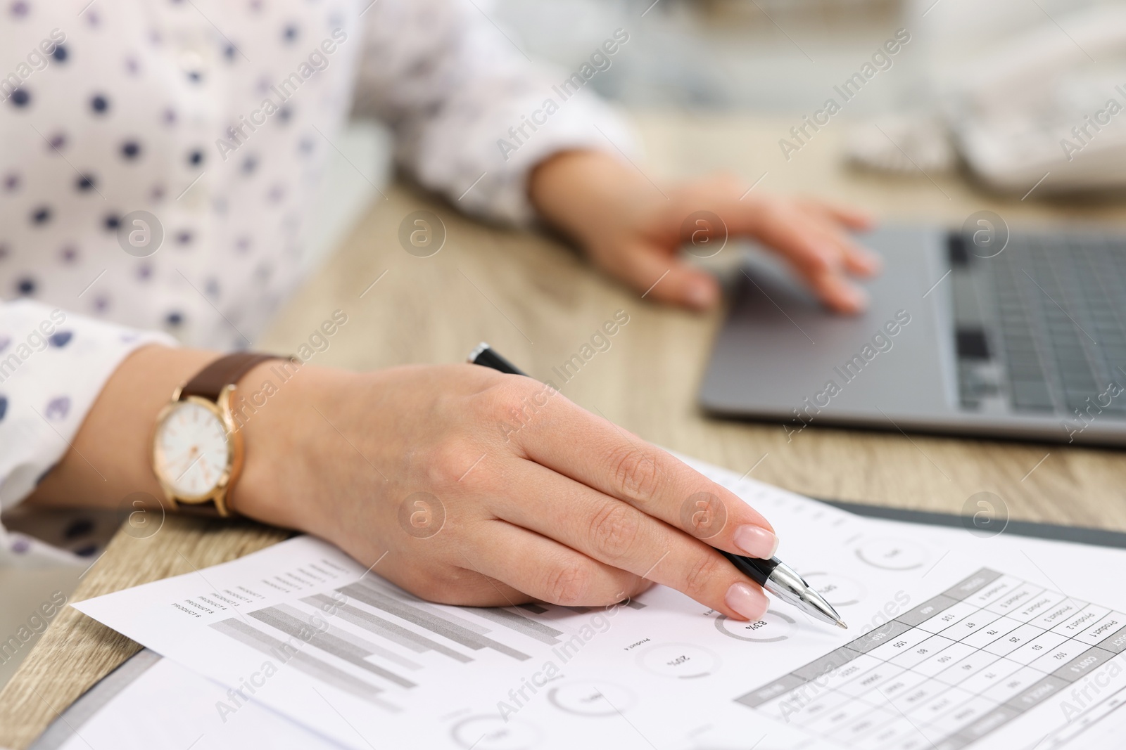 Photo of Secretary working at table in office, closeup