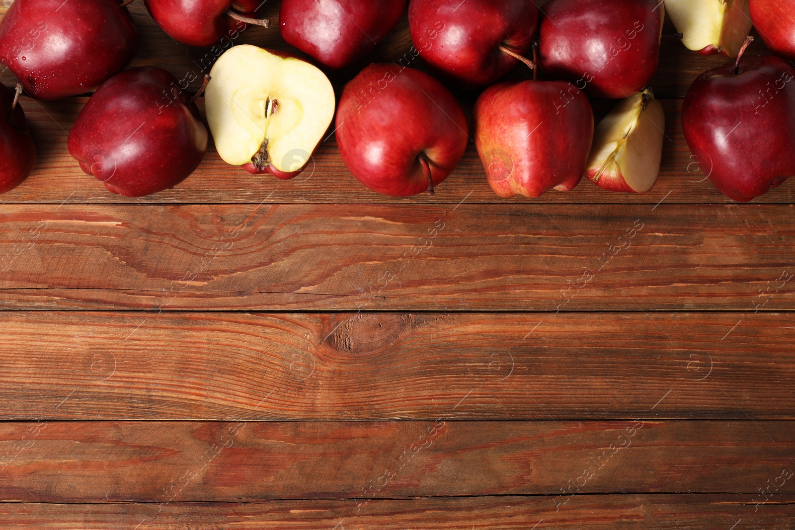 Photo of Fresh ripe red apples on wooden table, flat lay. Space for text