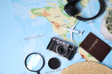 Photo of Travel blogger. Flat lay composition with vintage camera and map on light blue background