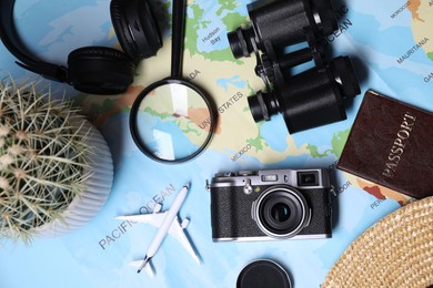 Photo of Flat lay composition with travel blogger`s items on light blue background