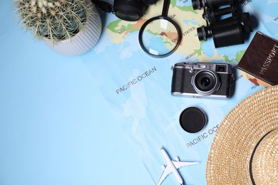 Photo of Travel blogger concept. Flat lay composition with vintage camera and map on light blue background, space for text