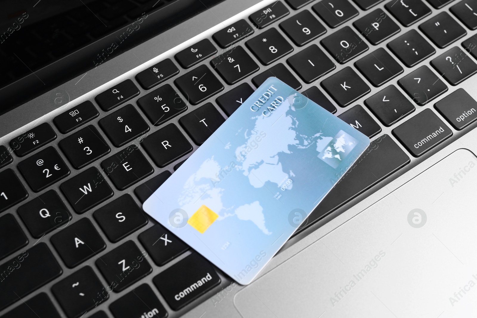 Photo of One credit card on laptop, above view