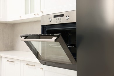 Photo of Open electric oven in kitchen. Cooking appliance