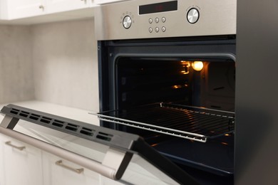 Photo of Open electric oven in kitchen. Cooking appliance