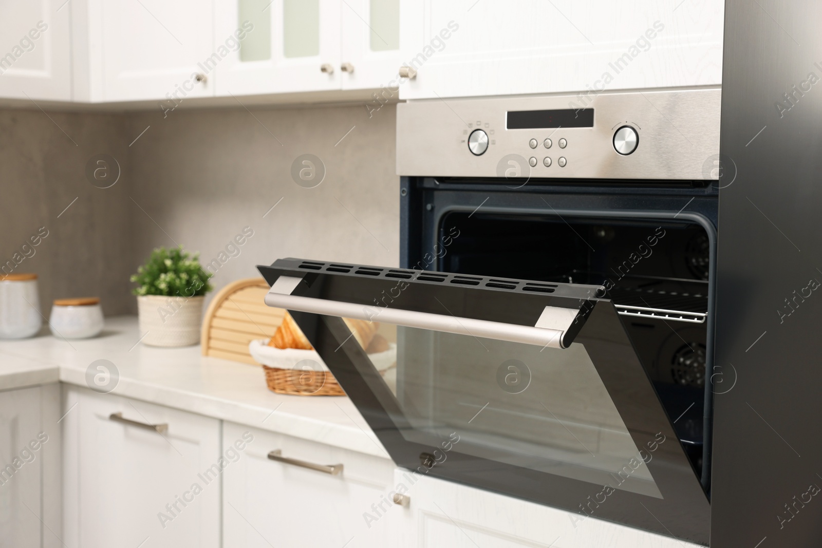 Photo of Open electric oven in kitchen. Cooking appliance