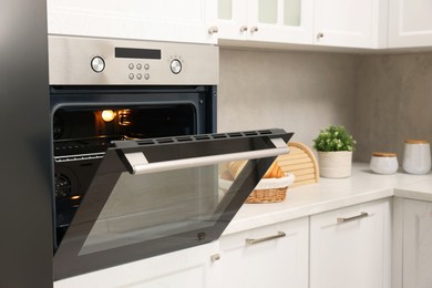 Open electric oven in kitchen. Cooking appliance