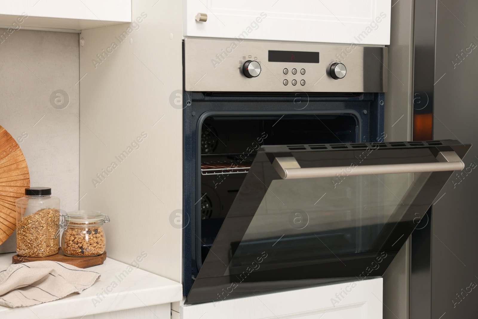 Photo of Open electric oven in kitchen. Cooking appliance