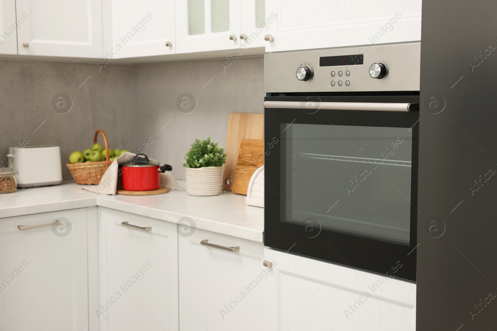 Photo of New electric oven in kitchen. Cooking appliance