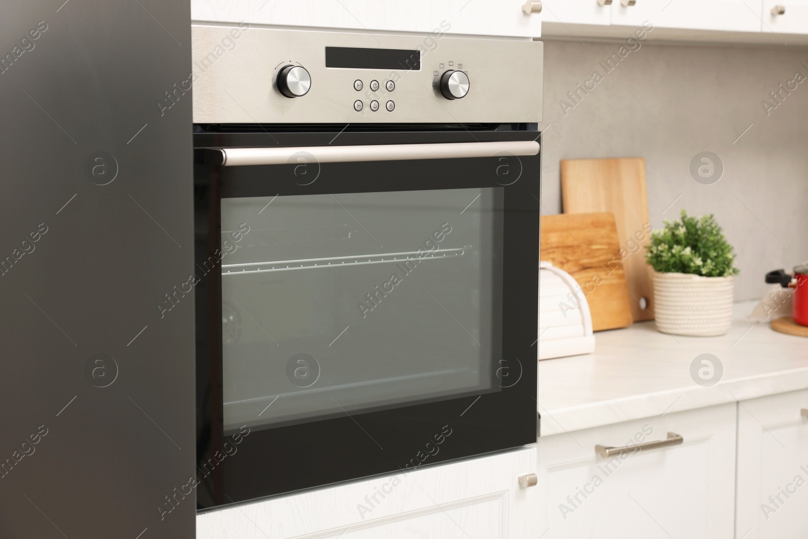 Photo of New electric oven in kitchen. Cooking appliance