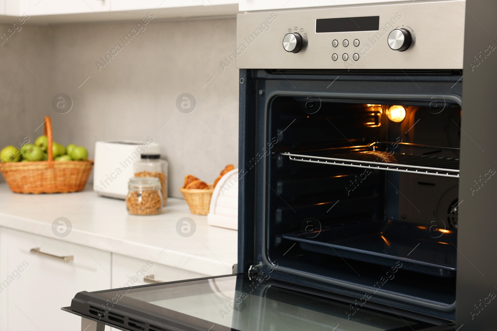 Photo of Open electric oven in kitchen. Cooking appliance