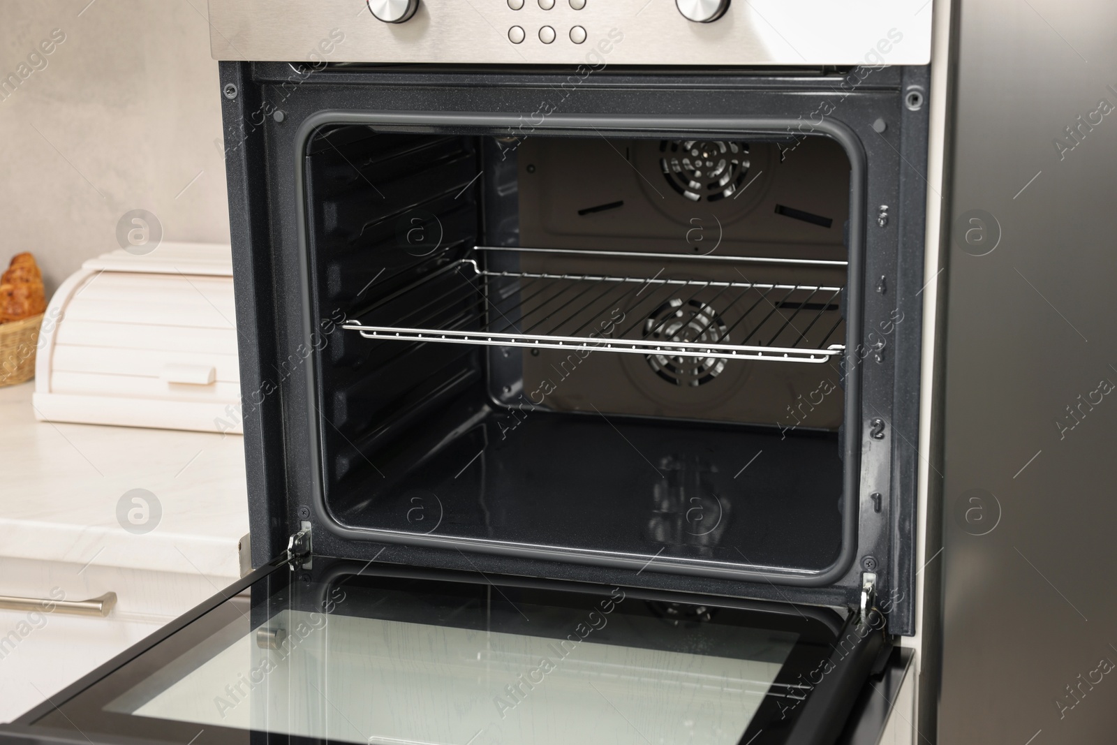 Photo of Open electric oven in kitchen. Cooking appliance