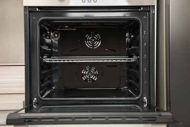 Photo of Open electric oven in kitchen. Cooking appliance